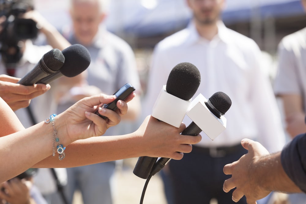 Reporters with microphones
