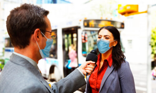 Best spokesperson for a media interview: male reporter with mask on interviews female spokesperson.