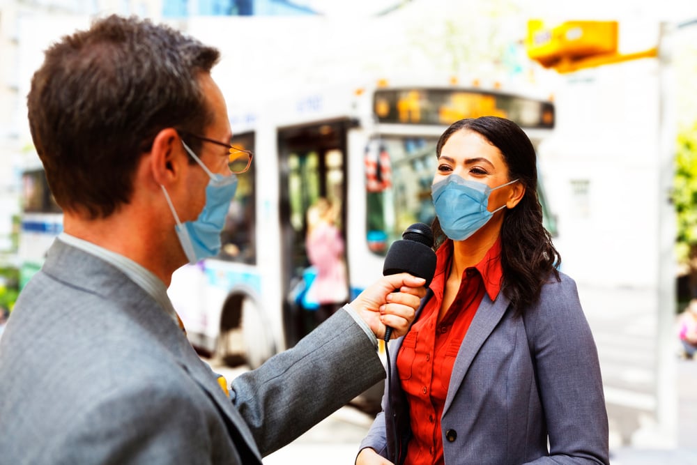 Best spokesperson for a media interview: male reporter with mask on interviews female spokesperson.