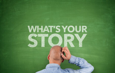 What is the best way to tell a corporate story with different business units? Man scratching his head in front of chalkboard that says "what's your story?"