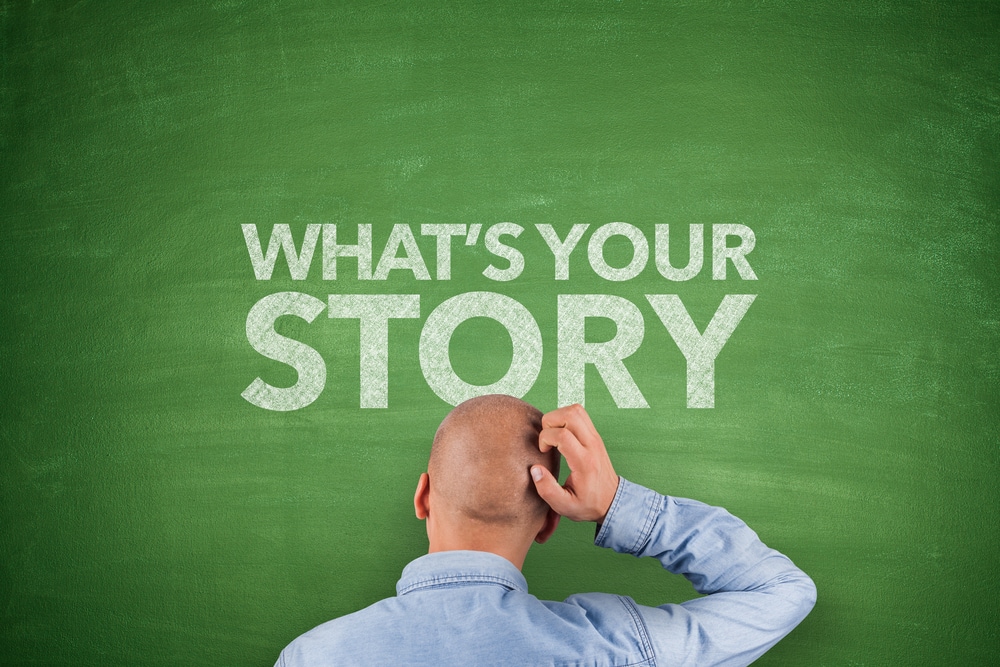 What is the best way to tell a corporate story with different business units? Man scratching his head in front of chalkboard that says "what's your story?"