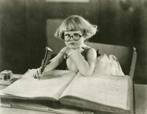 Little girl writing in an old photograph