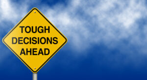 Road sign that read: Tough Decision Ahead